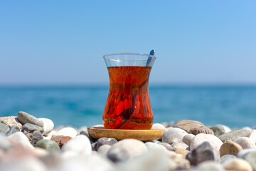 Armudu. Tea in a glass on the beach.