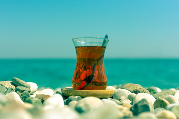 Armudu. Tea in a glass on the beach.