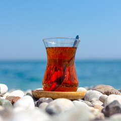 Armudu. Tea in a glass on the beach.