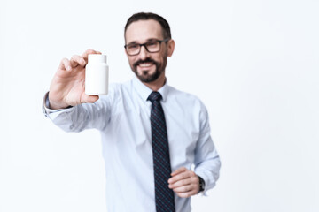 A man shows pills to camera and shows a medicine.