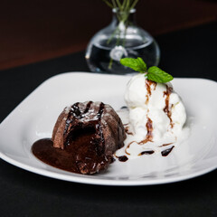 Plate of delicious fresh fondant with hot chocolate and ice cream on table, top view. Lava cake recipe