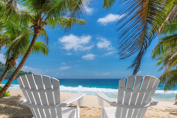 Paradise beach with white sand, beach chairs and coco palms in Caribbean sea. Summer vacation and tropical beach concept.	