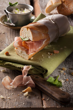 A baguette sandwich with Parma ham, spinach and cream cheese