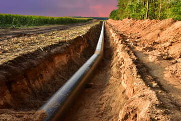Construction Gas Pipeline Project on amazing sunset background. Natural Gas and Crude oil...