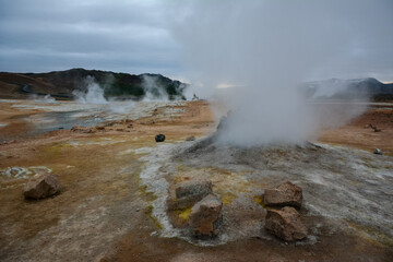 Boiling mudpots in the geothermal area Hverir and cracked ground around, Iceland in summer. Myvatn region, North part of Iceland