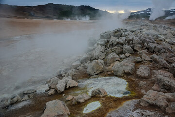 Boiling mudpots in the geothermal area Hverir and cracked ground around, Iceland in summer. Myvatn region, North part of Iceland