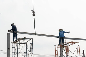 Construction Scaffolding Worker conect the steel beam by gas welding equipment