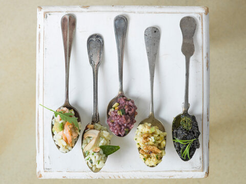 Different types of risotto on spoons