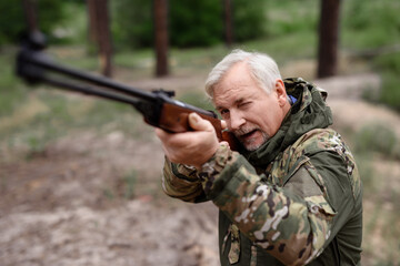 Grandfather Hunting in Summer Forest Taking Aim.