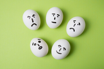 Eggs with different emotions on their faces: surprise, joy, sadness, anger and indifference