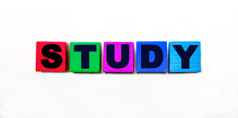 The word STUDY is written on colorful cubes on a light background