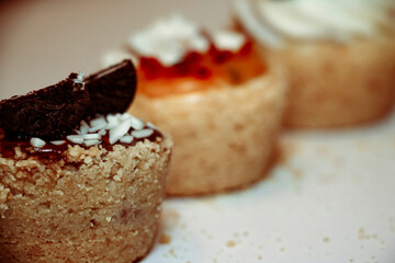 
Different types of muffins with cream and fillings on a white background
