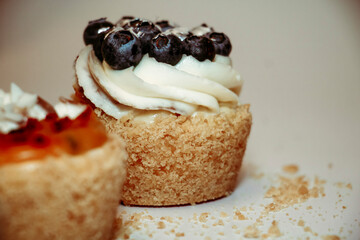 
Different types of muffins with cream and fillings on a white background