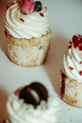 
Different types of muffins with cream and fillings on a white background
