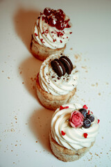 
Different types of muffins with cream and fillings on a white background