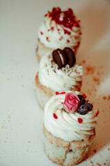 
Different types of muffins with cream and fillings on a white background