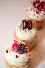 
Different types of muffins with cream and fillings on a white background