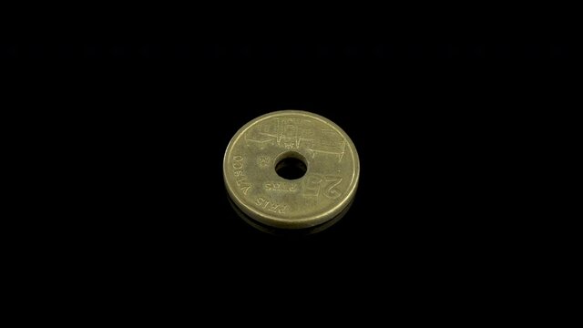 Old spanish 25 pesetas coin from 1993 with the facade of the O&ntilde;ate University and a hole in the center