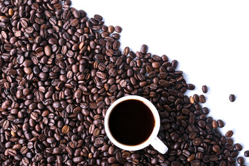 Coffee beans and cup of coffee isolated on white background