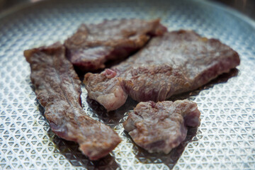 Grilled Korean beef cooked on a stainless steel frying plate