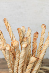 Delicious breadsticks grissini. Italian appetizers on a wooden table.