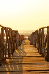 Wooden bridge leading to the sea. India