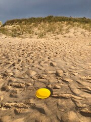 Fototapeta na wymiar yellow frisbee at the beach