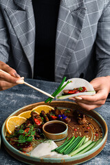 a woman eats a Peking duck