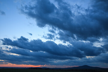 Stormy sky with storm clouns on the sunset with beautiful sun
