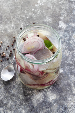 Pieces of herring marinated in oil with onion