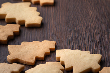 Top view of decorated Christmas tree cookie on wooden table background with copy space.