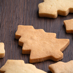 Top view of decorated Christmas tree cookie on wooden table background with copy space.