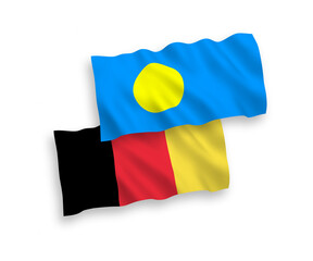 National vector fabric wave flags of Palau and Belgium isolated on white background. 1 to 2 proportion.