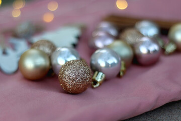 Various Christmas decorations and cinnamon sticks on pink background. Selective focus.