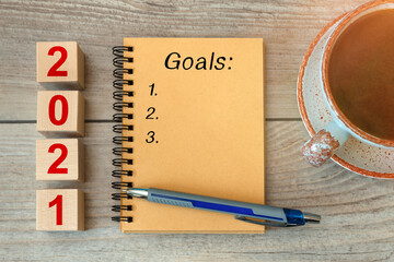 2021 GOALS - inscription on a notebook and wooden cubes