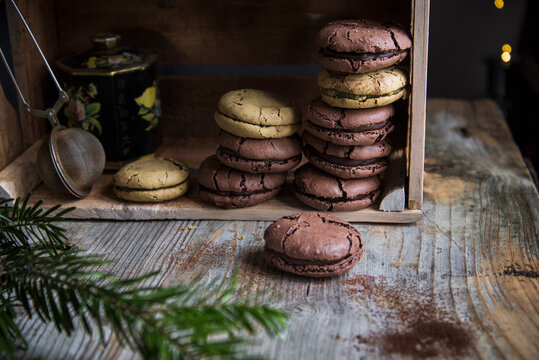 cracked macaroons on a wooden box ready to be shared to celebrate