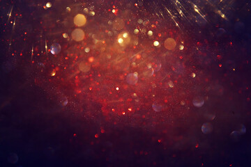 background of abstract red, gold and black glitter lights. defocused