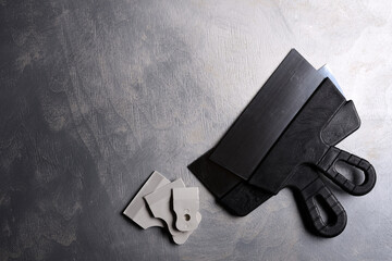 Spatulas for application of putty on a gray concrete background .Top view