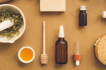 Composition of bottles with natural cosmetics and bath supplies on color background