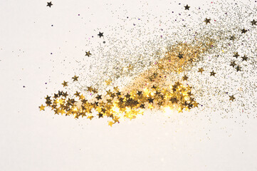 Gold glitter and glittering stars on light gray background in vintage colors