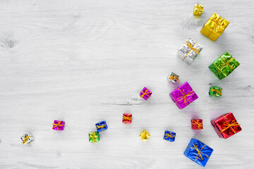 Multicolored bright holiday gift boxes of various sizes on a white background. Copy space