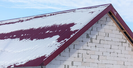 Snow on the roof of the house.