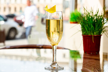 sparkling wine glass in cafe restaurant, sparkling wine in glass in a summer cafe