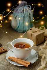 Cinnamon tea on a table decorated with garlands and gifts.
