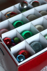Colorful Christmas ornaments organized in a box. Selective focus.