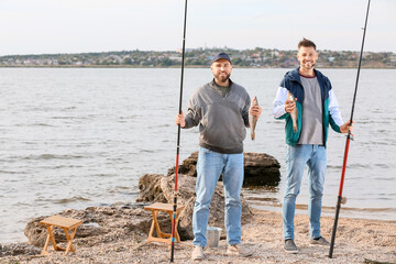 Young men fishing on river