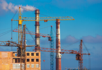 Building cranes and factory pipes