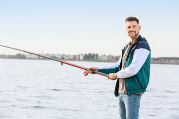 Young man fishing on river