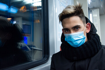 Fototapeta na wymiar Young attractive guy in a mask. Diseases and protection.