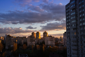 Sunset in the city. Clouds over the city of Kyiv. Metropolis background horizontal. 